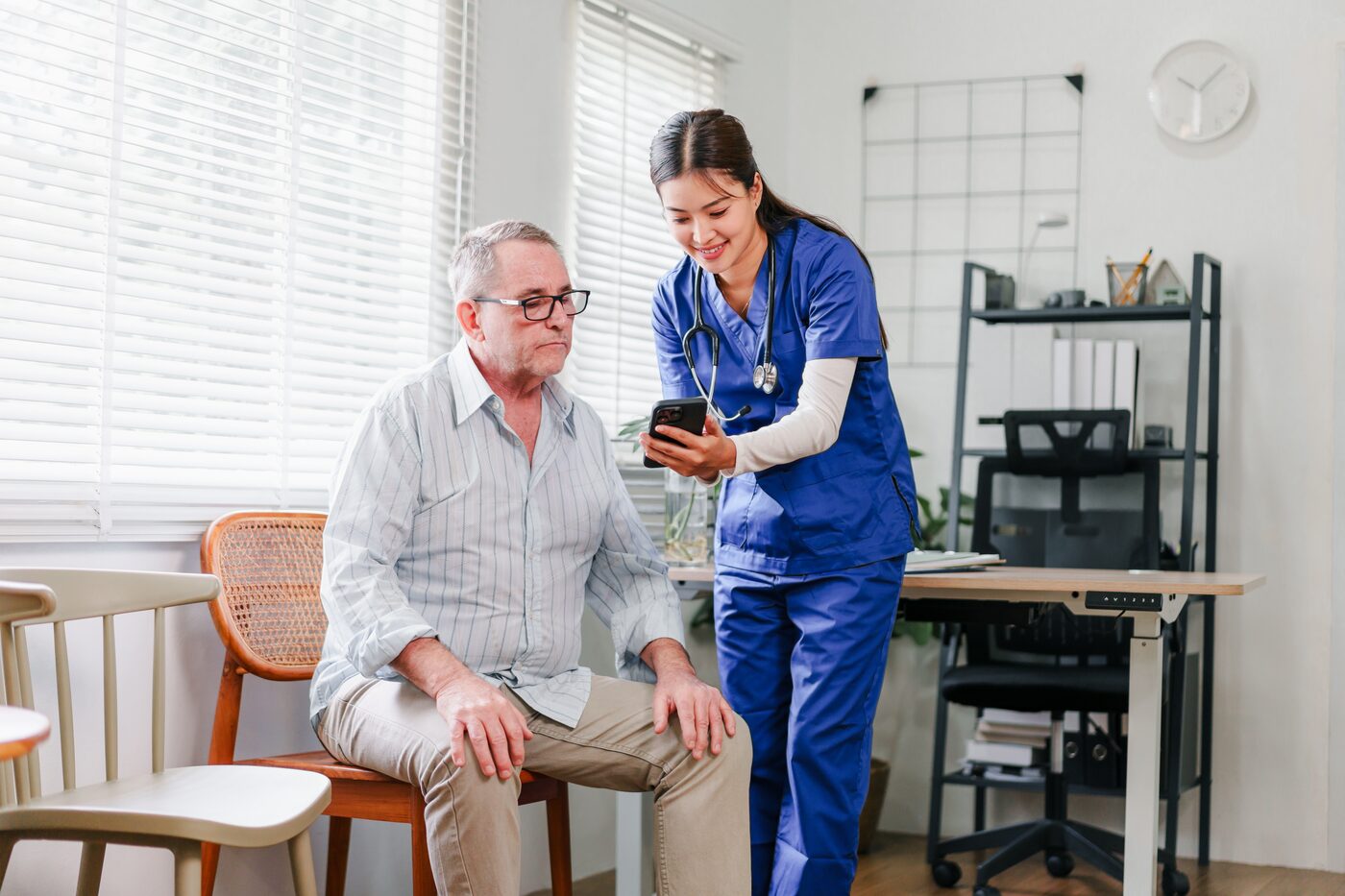 A nurse helping an older patient